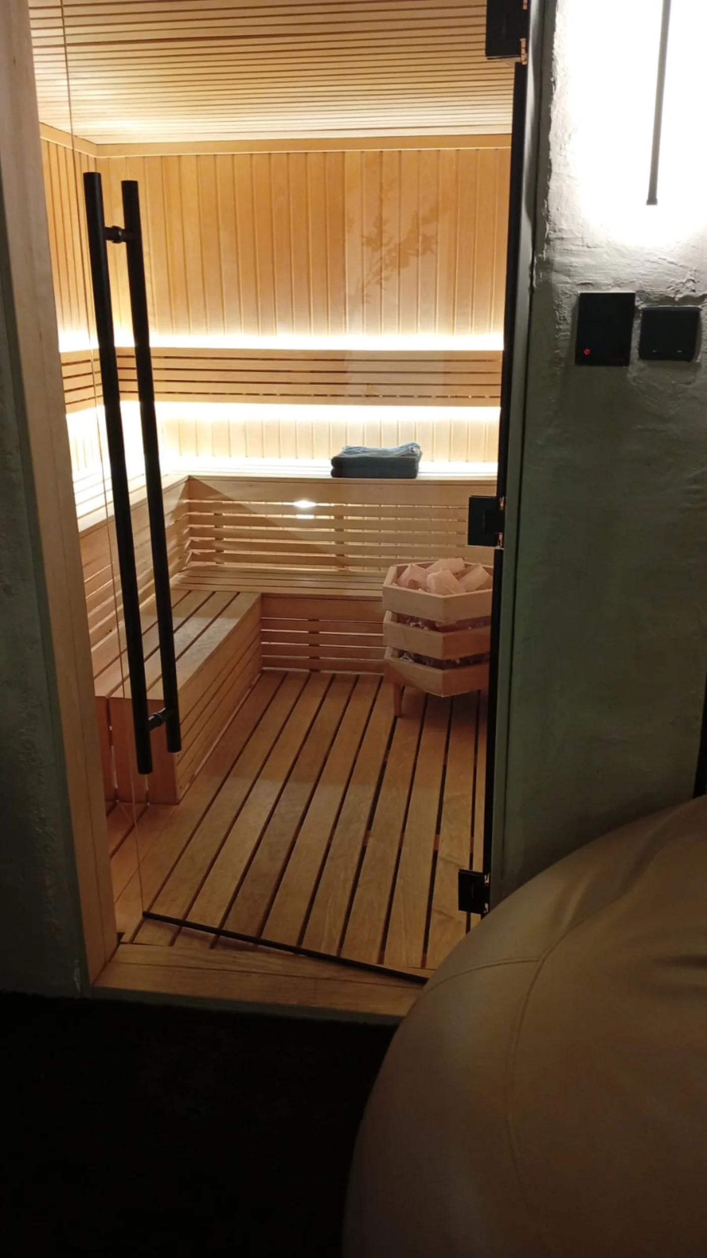 Custom glass-front sauna built around the room and available electrical capacity