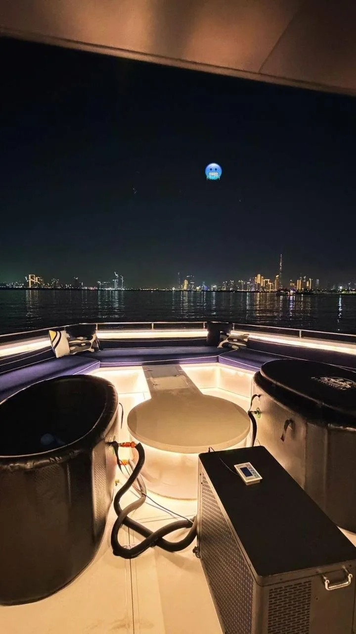 Two portable ice bath tubs on yacht deck with Dubai skyline