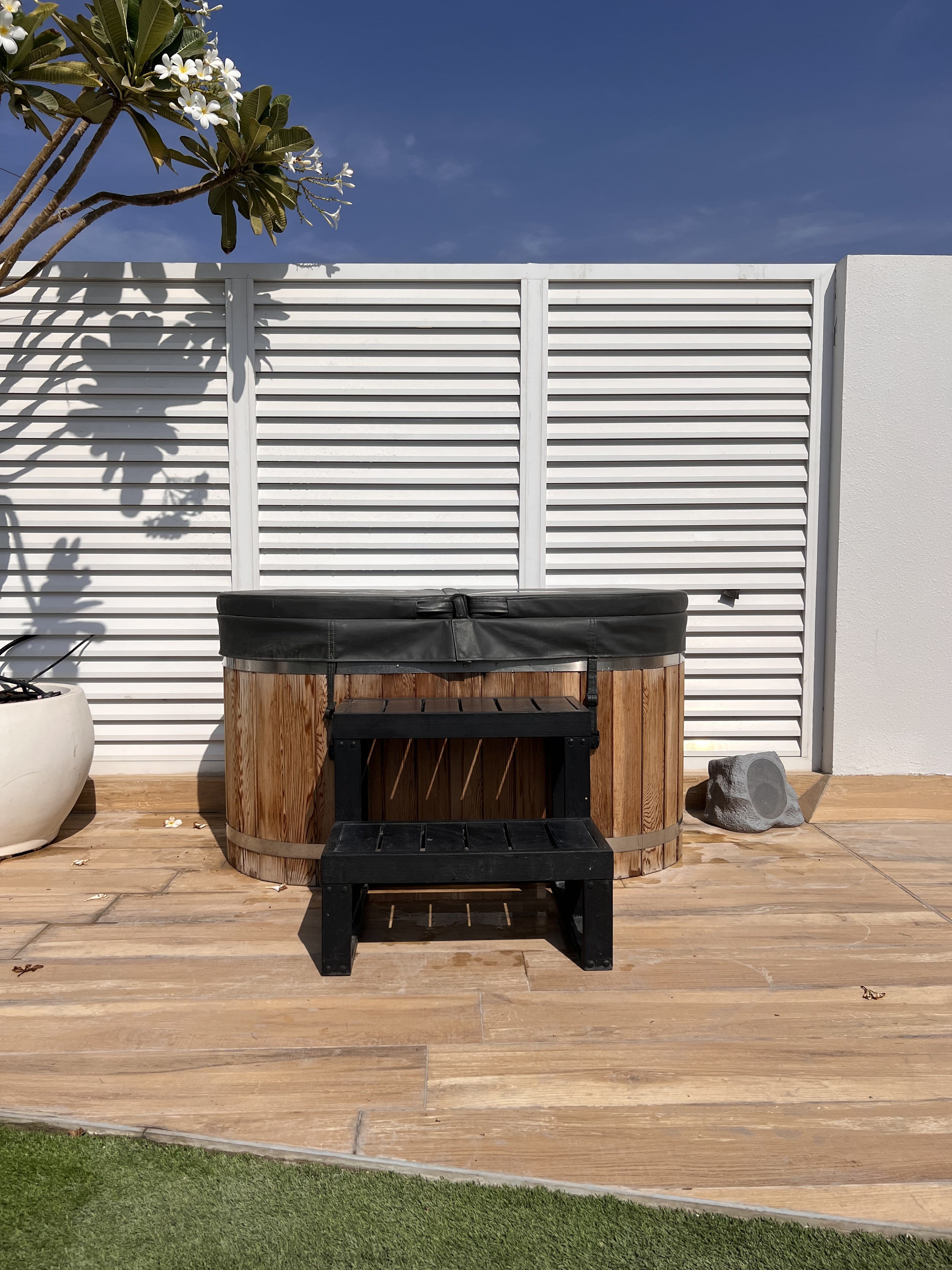 outdoor wooden barrel sauna installation in dubai garden